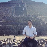 Nipun Khanna seated in front of a pyramid